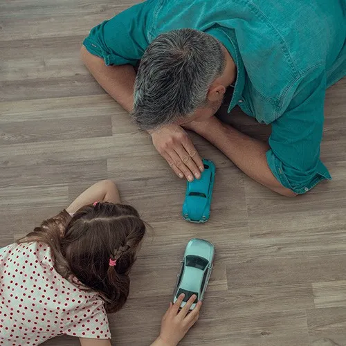 After-VinylInstall Girl and father playing with toy cars | Howard-Carpenter Floor Covering