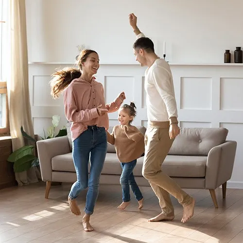 AfterLaminateInstall Family playing in living room | Howard-Carpenter Floor Covering