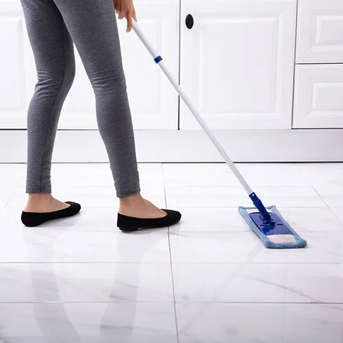 Basic-Care-Tile-Flooring Lady cleaning tile | Howard-Carpenter Floor Covering